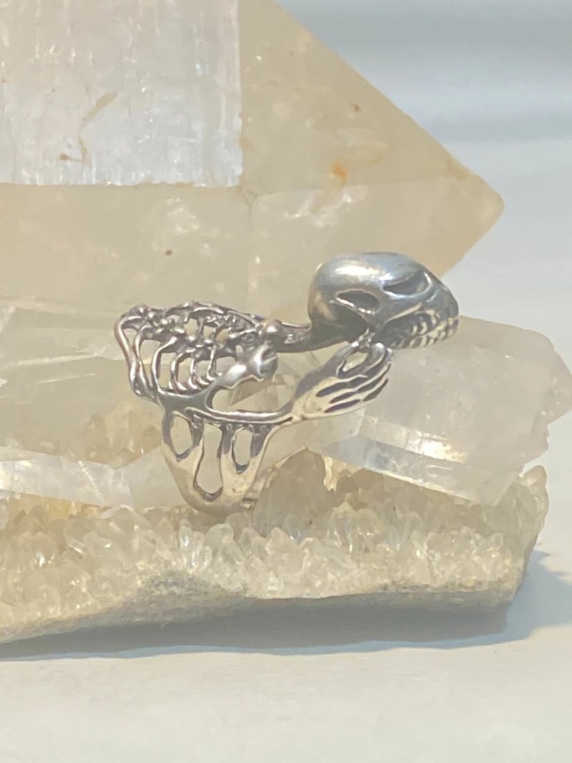 SKULL RING SKELETON BIKER BAND STERLING SILVER WOMEN: SKULL RING SKELETON BIKER BAND STERLING SILVER WOMEN Skull ring skeleton biker band sterling silver women Size 9 AS IS Band Is CUT Weight 11.8g Length. 1. 1/2" Width 3/4" Thinnest part of band 3/16"
