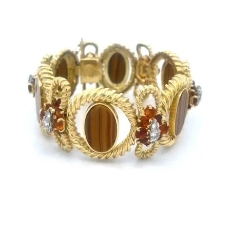 LA TRIOMPHE DIAMOND BRACELET CITRINE TIGER'S EYE CABLE OVAL BOW LINKS: LA TRIOMPHE DIAMOND BRACELET CITRINE TIGER'S EYE CABLE OVAL BOW LINKS This is a gorgeous authentic bracelet by La Triomphe, it is crafted from 18k yellow gold featuring alternating thick grooved wire 