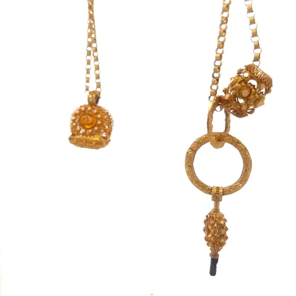 EDWARDIAN GOLD FOB WATCH CHAIN 17-18K FILIGREE GEMSTONE MOTIFS: EDWARDIAN GOLD FOB WATCH CHAIN 17-18K FILIGREE GEMSTONE MOTIFS Experience the elegance of the Edwardian era with this stunning gold fob watch chain. Crafted between 1901 and 1910, this piece boasts a 