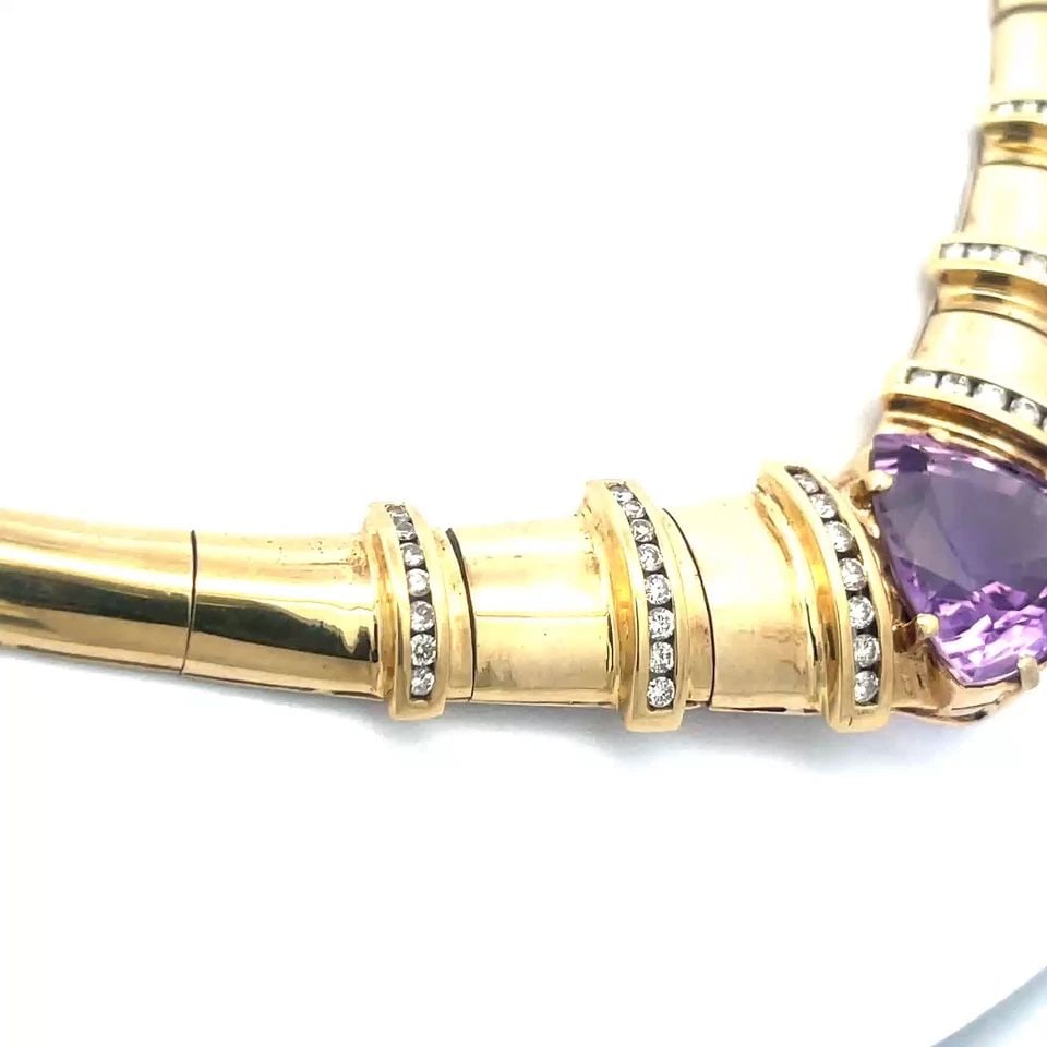 DIAMOND GOLD NECKLACE 14K YELLOW AMETHYST COLLAR STYLE: The diamond and 14k yellow gold necklace is a stunning piece of fine jewelry featuring a pear-shaped pendant with a large prong set amethyst gemstone, on each side of the gemstone are strips with natu