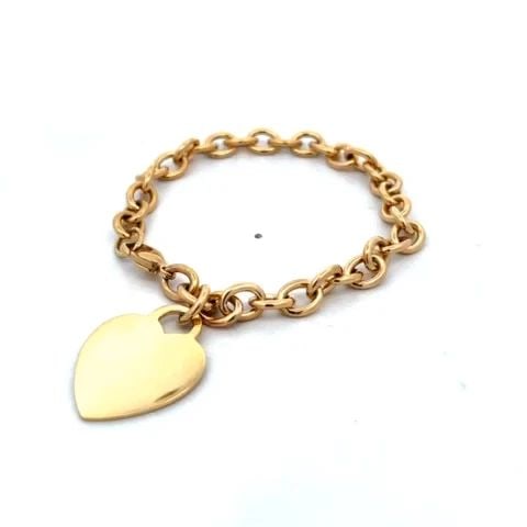 TIFFANY & CO. HEART CHARM BRACELET 18K YELLOW GOLD OVAL LINK CHAIN: TIFFANY & CO. HEART CHARM BRACELET 18K YELLOW GOLD OVAL LINK CHAIN This lovely bracelet is by Tiffany & Co. from the Heart Tag Charm Collection. It is crafted from 18k yellow gold featuring large oval