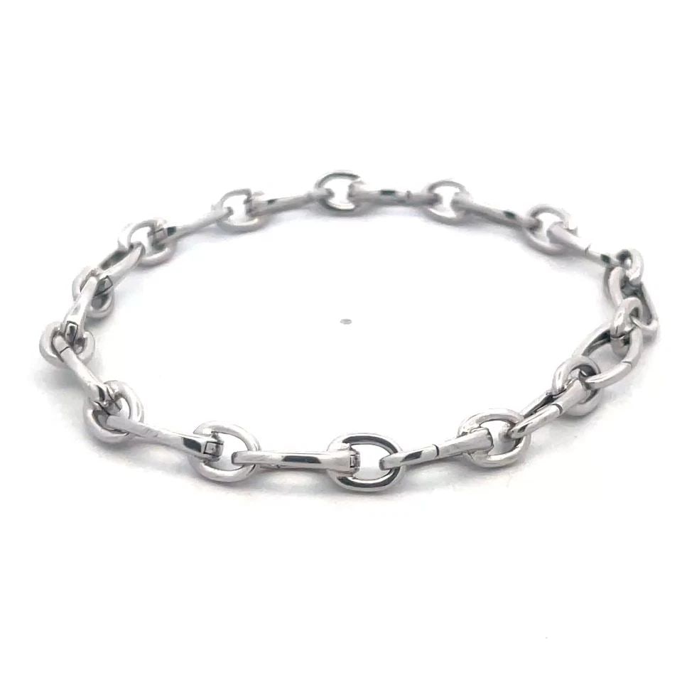 TIFFANY & CO. CLASPING LINK GOLD BRACELET 18K WHITE MARQUISE SHAPE CHAIN: TIFFANY & CO. CLASPING LINK GOLD BRACELET 18K WHITE MARQUISE SHAPE CHAIN This Tiffany & Co. Clasping Link Gold Bracelet is a classic piece of fine jewelry made of 18K white gold. It features alternati