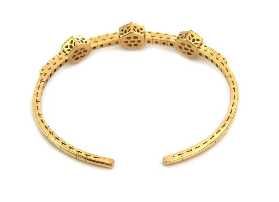 DIAMOND BRACELET GOLD 18KT YELLOW 3 STATION FLEX BAND CUFF: DIAMOND BRACELET GOLD 18KT YELLOW 3 STATION FLEX BAND CUFF This 18kt yellow gold bracelet features a cuff style design with three stations of round-cut white diamonds set in the gold band. The flexibl