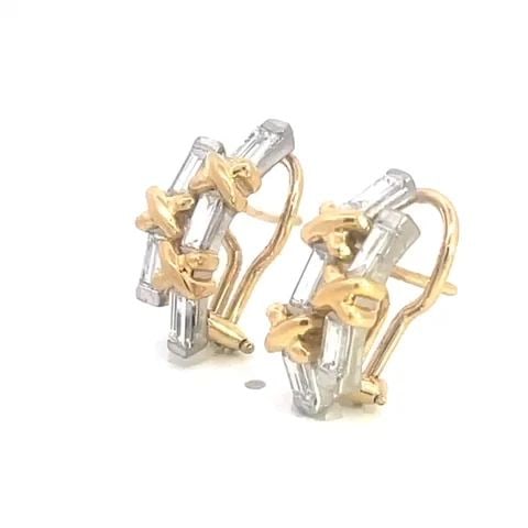 DIAMOND CURVED HUGGIE EARRINGS 18K TWO TONE GOLD X DESIGN: DIAMOND CURVED HUGGIE EARRINGS 18K TWO TONE GOLD X DESIGN This lovely pair of earrings are crafted from 18k white and yellow gold featuring a double row curved bar in white gold with emerald cut diamo