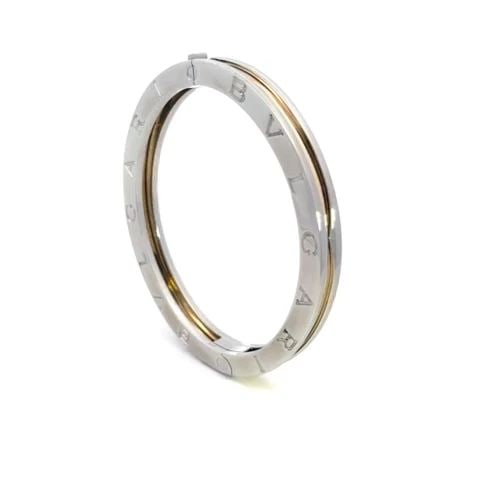 BULGARI B ZERO-1 BANGLE STEEL & 18K YELLOW GOLD ENGRAVED SIDES: BULGARI B ZERO-1 BANGLE STEEL & 18K YELLOW GOLD ENGRAVED SIDES This chic authentic bracelet is by Bvlgari from the B Zero.1 Collection. It is a small size and crafted from stainless steel with 18k yel