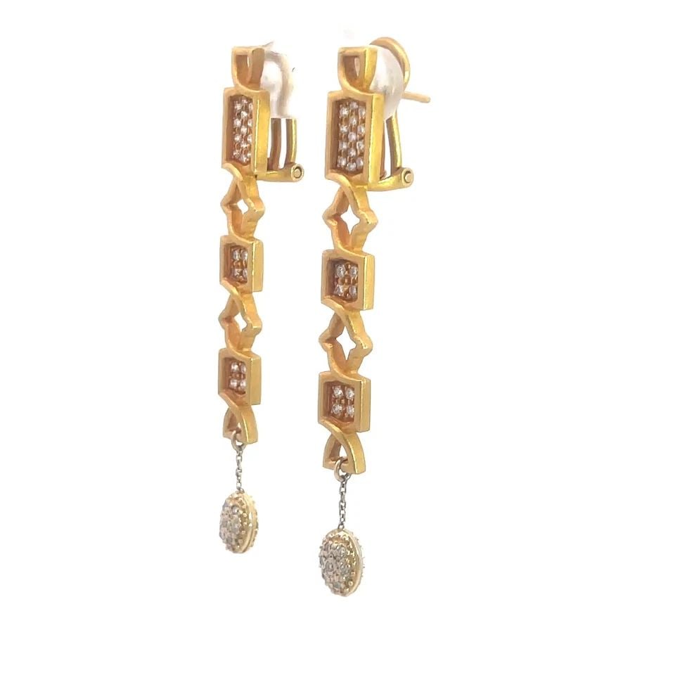 FIBULA DIAMOND GOLD EARRINGS 18K YELLOW LONG DANGLE STYLE: FIBULA DIAMOND GOLD EARRINGS 18K YELLOW LONG DANGLE STYLE Elevate your jewelry collection with the exquisite Fibula Diamond Gold Earrings, crafted in 18k yellow gold and featuring a stunning pavéd di