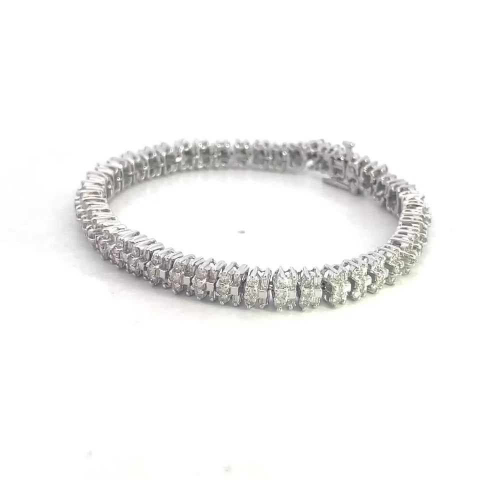 DIAMOND GOLD TENNIS BRACELET 14K WHITE CLUSTER BAGUETTE AND ROUND: DIAMOND GOLD TENNIS BRACELET 14K WHITE CLUSTER BAGUETTE AND ROUND 4. This is a stunning diamond tennis bracelet, it is crafted from 14k white gold with a polished finish featuring flex small link fram