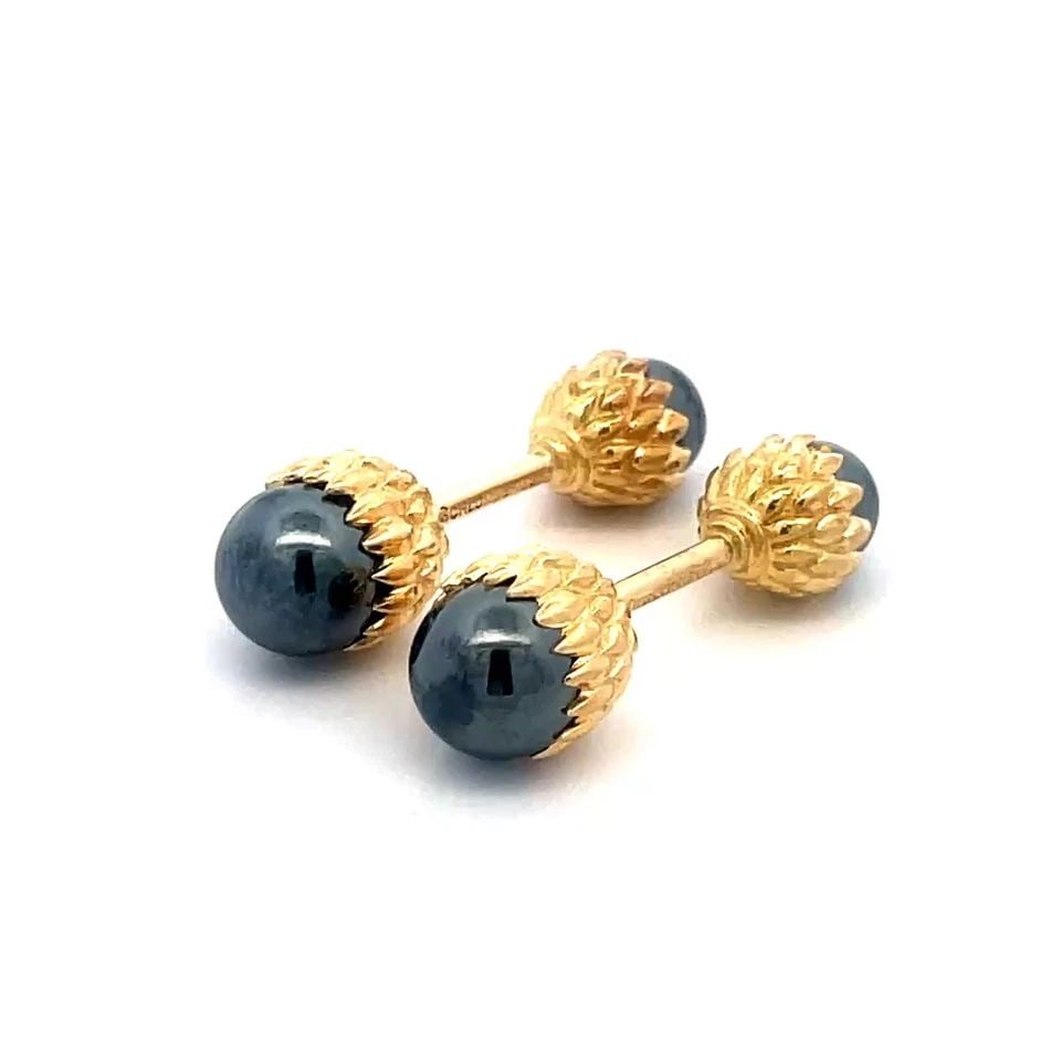 TIFFANY & CO. SCHLUMBERGER GOLD CUFFLINKS 18K YELLOW HEMATITE ACORN STYLE: TIFFANY & CO. SCHLUMBERGER GOLD CUFFLINKS 18K YELLOW HEMATITE ACORN STYLE These Tiffany & Co. Schlumberger gold cufflinks feature a unique acorn style design, with a black hematite cabochon stone set 