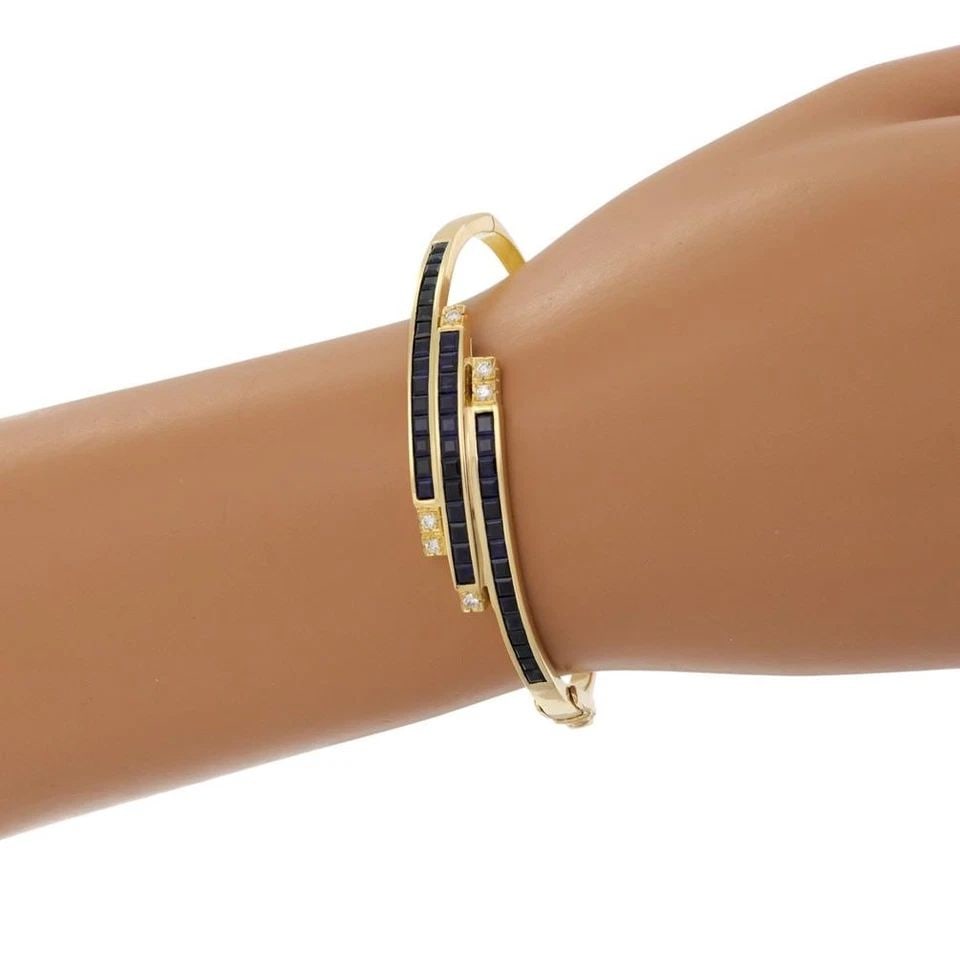 SAPPHIRE DIAMOND BRACELET 18K YELLOW GOLD BYPASS: Lovely 6.24ct Sapphire Diamond 18k Yellow Gold Bypass Bracelet Description This is a lovely bracelet, crafted from 18k yellow gold and has a slide in clasp on the side, the back half is 2.5mm wide in 