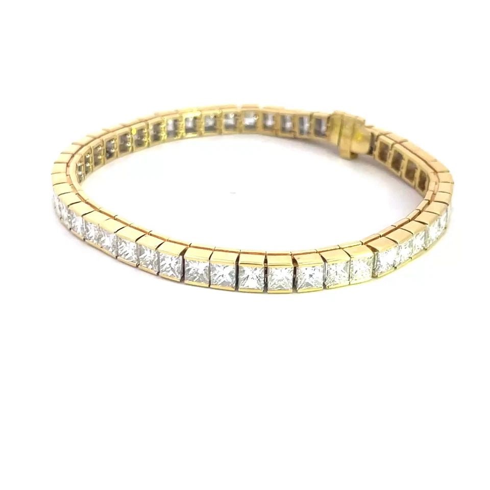 DIAMOND GOLD TENNIS BRACELET 16.CT PRINCESS CUT 18K YELLOW GOLD: DIAMOND GOLD TENNIS BRACELET 16.CT PRINCESS CUT 18K YELLOW GOLD Stunning diamond tennis bracelet, it is crafted from 18k yellow gold featuring cube links with princess cut half bezel set diamonds. The