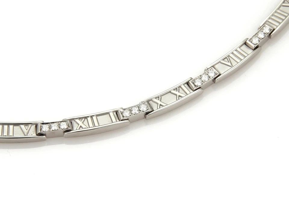 TIFFANY & CO. ATLAS DIAMOND NECKLACE 18K WHITE GOLD CURVED BAR COLLAR: TIFFANY & CO. ATLAS DIAMOND NECKLACE 18K WHITE GOLD CURVED BAR COLLAR The Tiffany & Co. ATLAS Diamond Necklace is a stunning 18k white gold piece featuring a curved bar collar with round diamonds. Thi