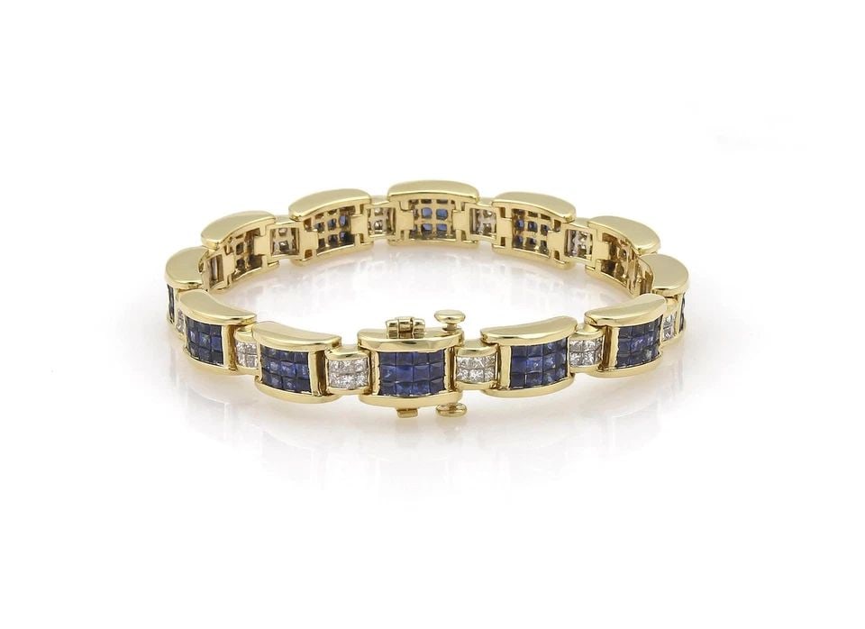 DIAMOND & SAPPHIRE BRACELET IN 18K YELLOW GOLD PRINCESS CUT INVISIBLY SET: DIAMOND & SAPPHIRE BRACELET IN 18K YELLOW GOLD PRINCESS CUT INVISIBLY SET 18k Yellow Gold Princess Cut Diamond & Sapphire Invisibly Set Bracelet Description This magnificent bracelet is crafted from 1