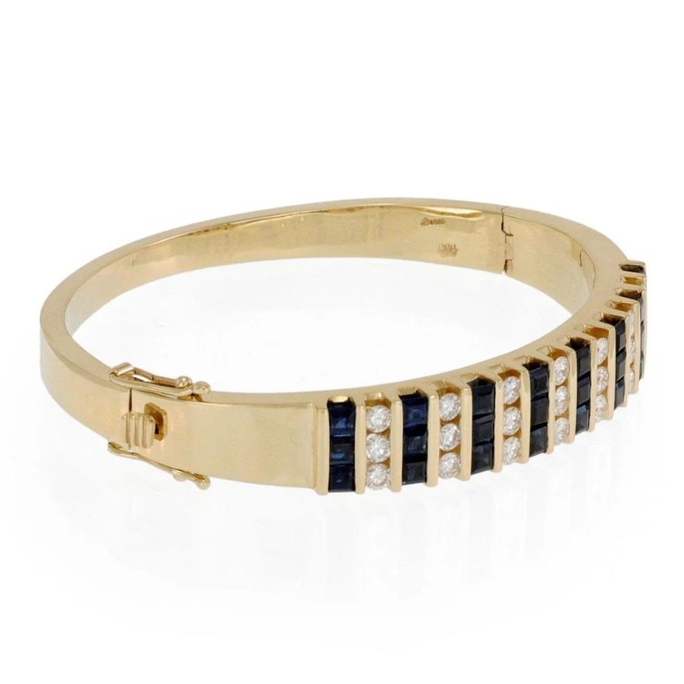 DERCO SIGNED 6.30CT DIAMOND SAPPHIRE 14K YELLOW GOLD HINGE BANGLE: DERCO SIGNED 6.30CT DIAMOND SAPPHIRE 14K YELLOW GOLD HINGE BANGLE Derco Signed 6.30ct Diamond Sapphire 14k Yellow Gold Hinge Bangle Description This is a designer signed bracelet by Derco, it is a gor