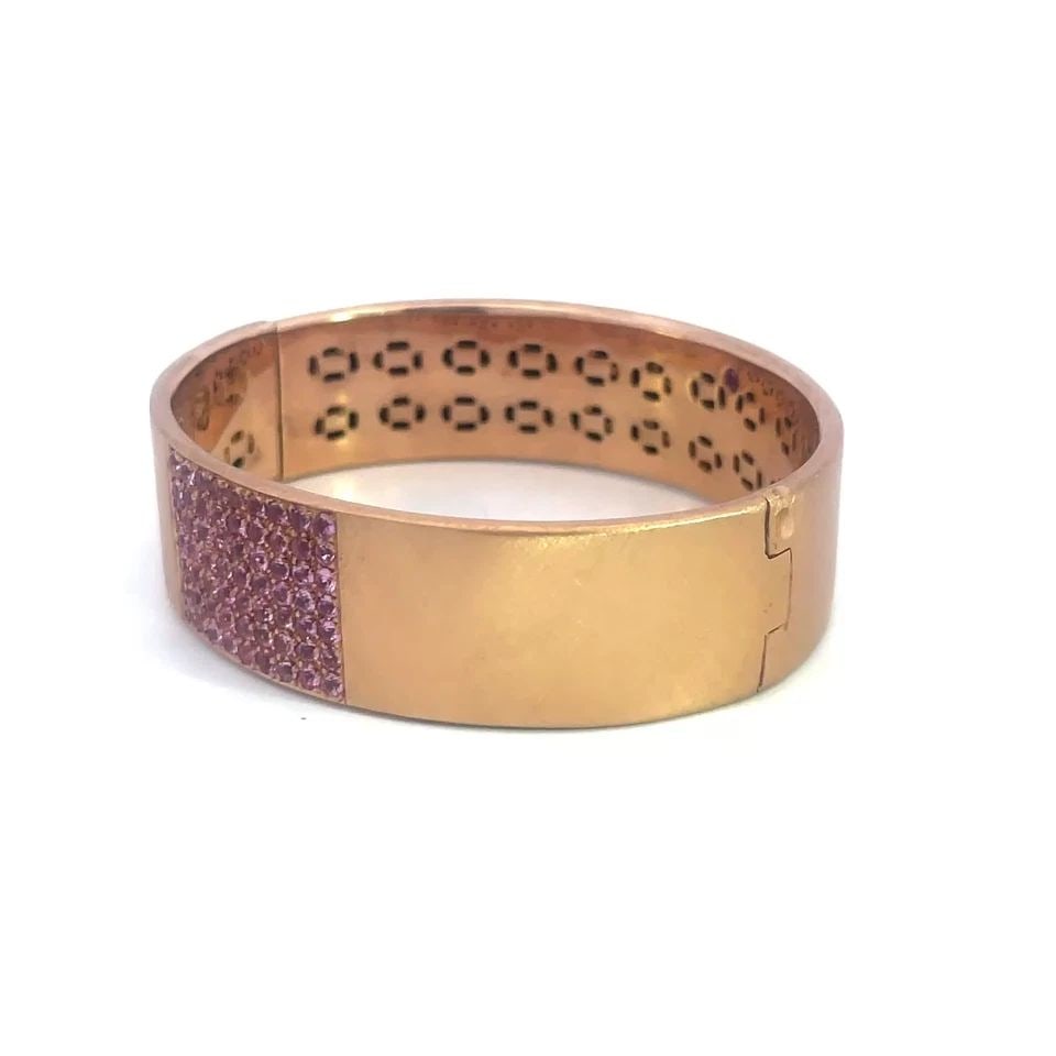ROBERTO COIN GOLD SAPPHIRE BRACELET 18K PINK WIDE HINGED BAND: ROBERTO COIN GOLD SAPPHIRE BRACELET 18K PINK WIDE HINGED BAND This chic fashionable wide band bracelet is by Roberto Coin, it is a stunning piece of fine jewelry made in Italy. Featuring an oval shape