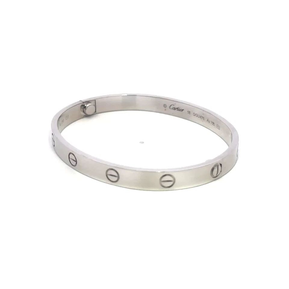 CARTIER LOVE GOLD BANGLE CLASSIC MODEL 18K WHITE SIZE 18 BOX CERT & PAPER: CARTIER LOVE GOLD BANGLE CLASSIC MODEL 18K WHITE SIZE 18 BOX CERT & PAPER This elegant bangle is by Cartier, from 18k white gold, it features a screw closure and signed by the brand. This classic mode