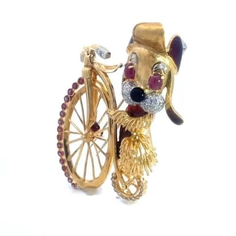 DOG RIDING BICYCLE GOLD BROOCH ENAMEL DIAMONDS & GEMS SPECIAL!!: DOG RIDING BICYCLE GOLD BROOCH ENAMEL DIAMONDS & GEMS SPECIAL!! This is an adorable handcrafted vintage brooch features an 18k yellow and white gold large dog on bicycle. The dog has on a cap with whi