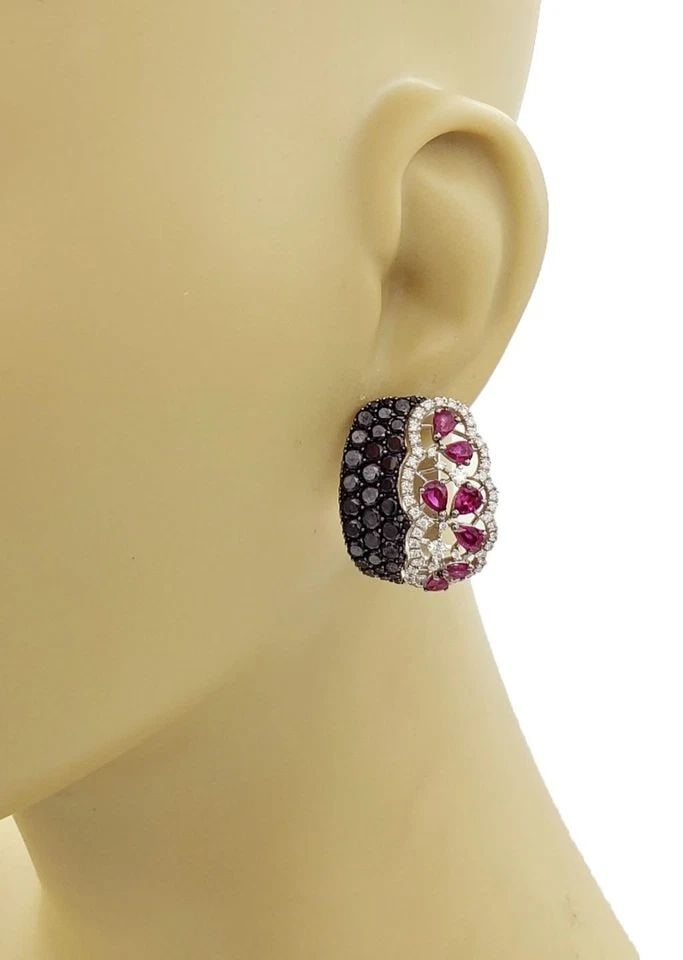 EARRINGS BLACK WHITE DIAMOND & GEMSTONES 18K GOLD FLORAL HUGGIE: EARRINGS BLACK WHITE DIAMOND & GEMSTONES 18K GOLD FLORAL HUGGIE These earrings feature a beautiful floral design with black and white diamonds and gemstones set in 18k gold. The huggie style makes the
