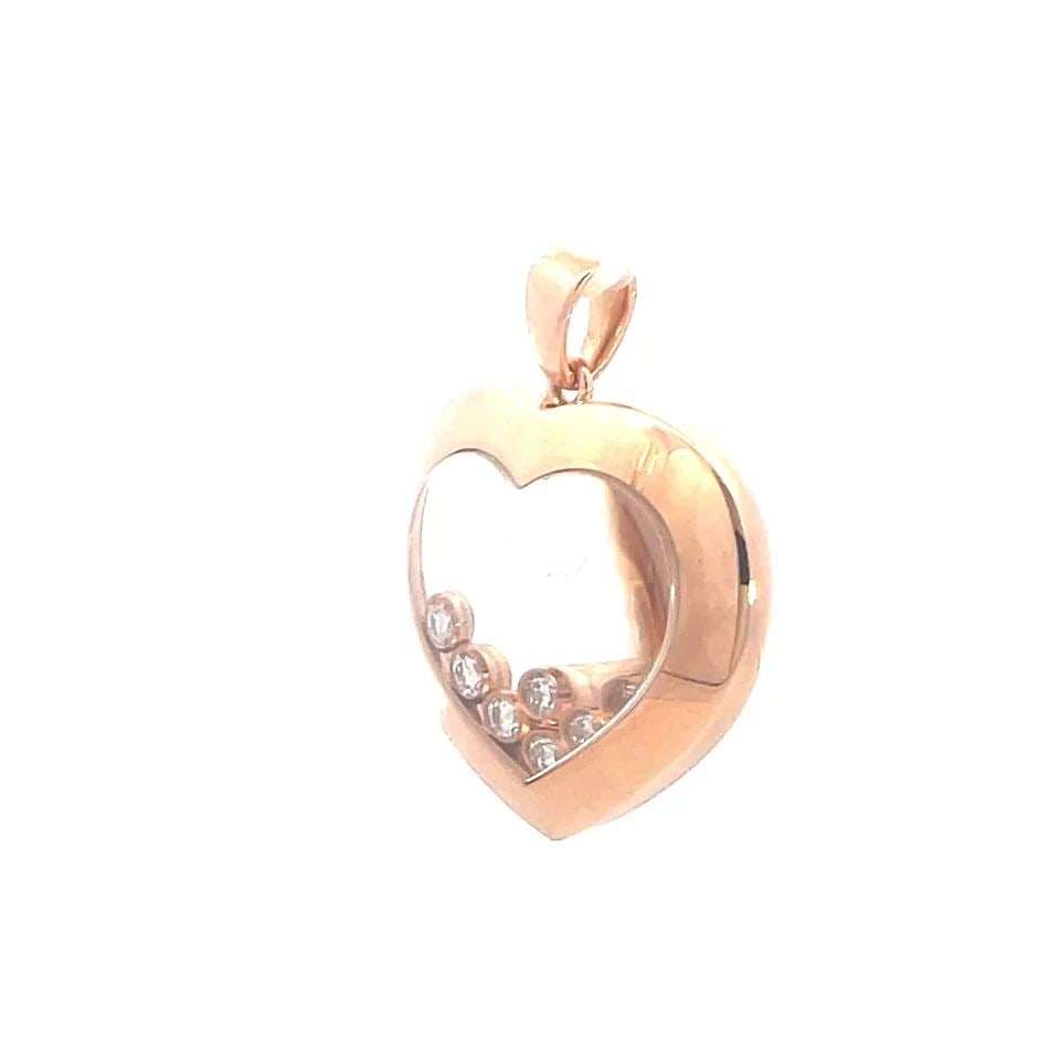 CHOPARD HAPPY DIAMOND GOLD PENDANT 18K ROSE 7 FLOATING HEART SHAPE: CHOPARD HAPPY DIAMOND GOLD PENDANT 18K ROSE 7 FLOATING HEART SHAPE This charming authentic pendant is by Chopard from the Happy Diamond Collection. It is crafted from 18k rose gold with a polished fin