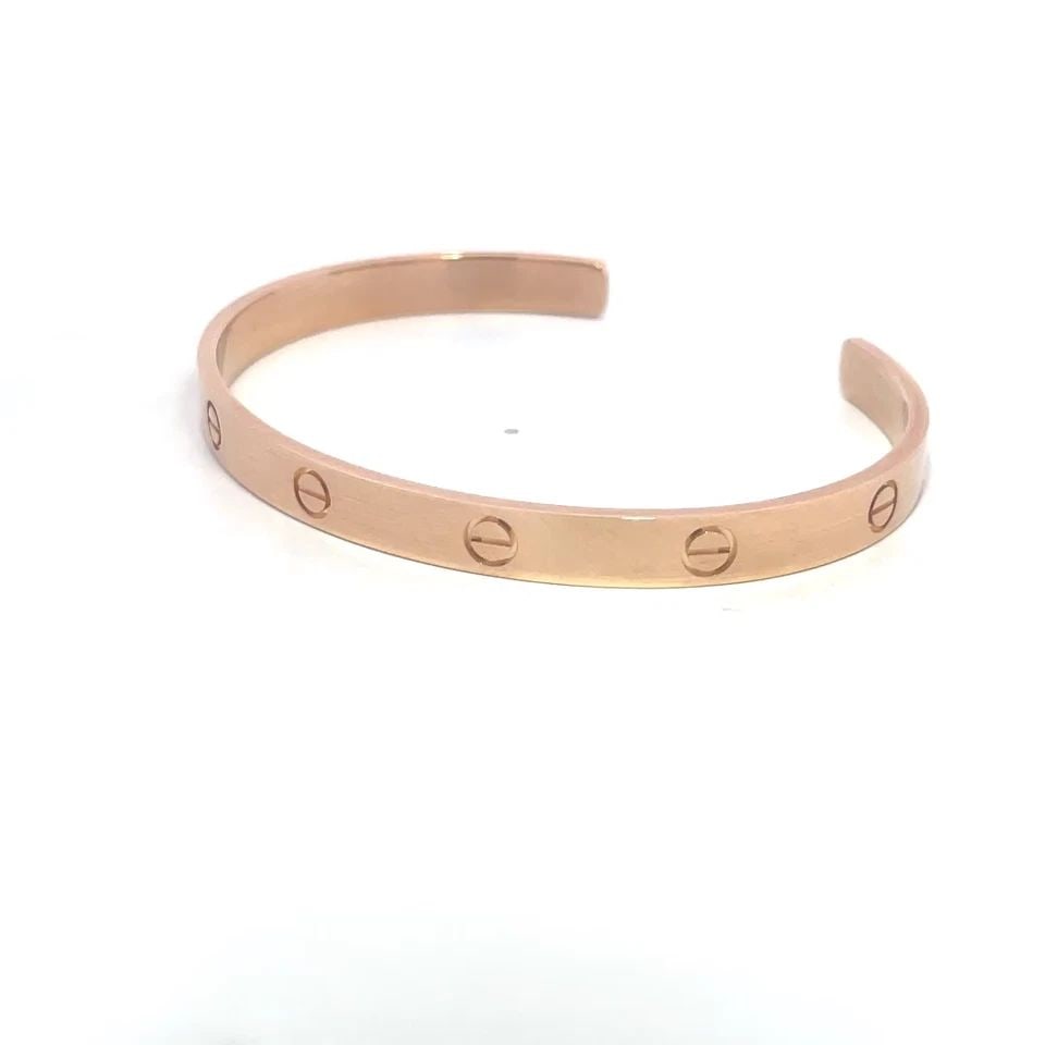 CARTIER LOVE BRACELET 18K ROSE GOLD SCREW MOTIFS SIZE 21 POCH PAPER: CARTIER LOVE BRACELET 18K ROSE GOLD SCREW MOTIFS SIZE 21 POCH PAPER This popular bracelet is by Cartier from the Love Collection; it is a luxurious piece of fine jewelry crafted from 18k rose gold fea