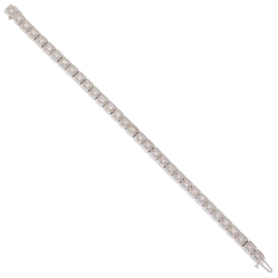 DIAMOND BRACELET 14K WHITE GOLD SQUARE LINK ESTATE: DIAMOND BRACELET 14K WHITE GOLD SQUARE LINK ESTATE This diamond bracelet features a square link design in 14k white gold. The stones are round-cut natural white diamonds set in a prong setting. The br