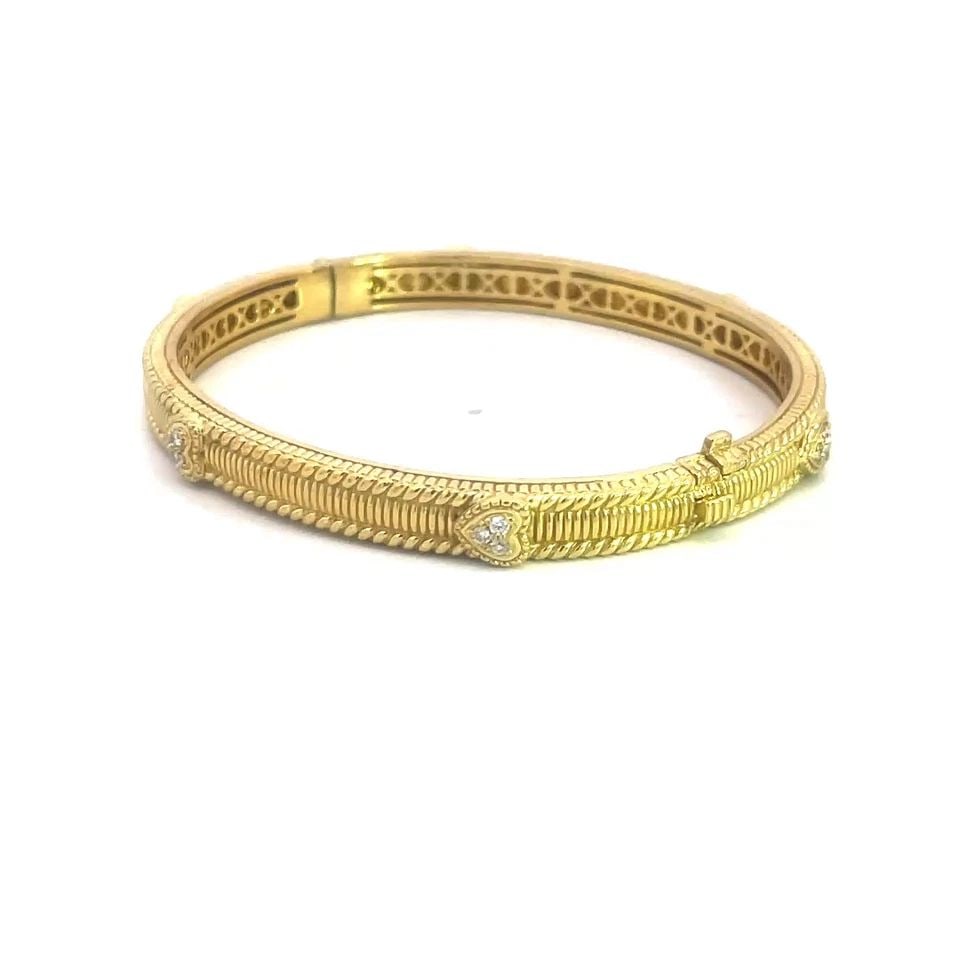 JUDITH RIPKA DIAMOND GOLD BANGLE 18K YELLOW HEART BEAD STYLE: JUDITH RIPKA DIAMOND GOLD BANGLE 18K YELLOW HEART BEAD STYLE The Judith Ripka Diamond Gold Bangle is a stunning piece of fine jewelry featuring 18k yellow gold oval shaped hinged band with slide clasp