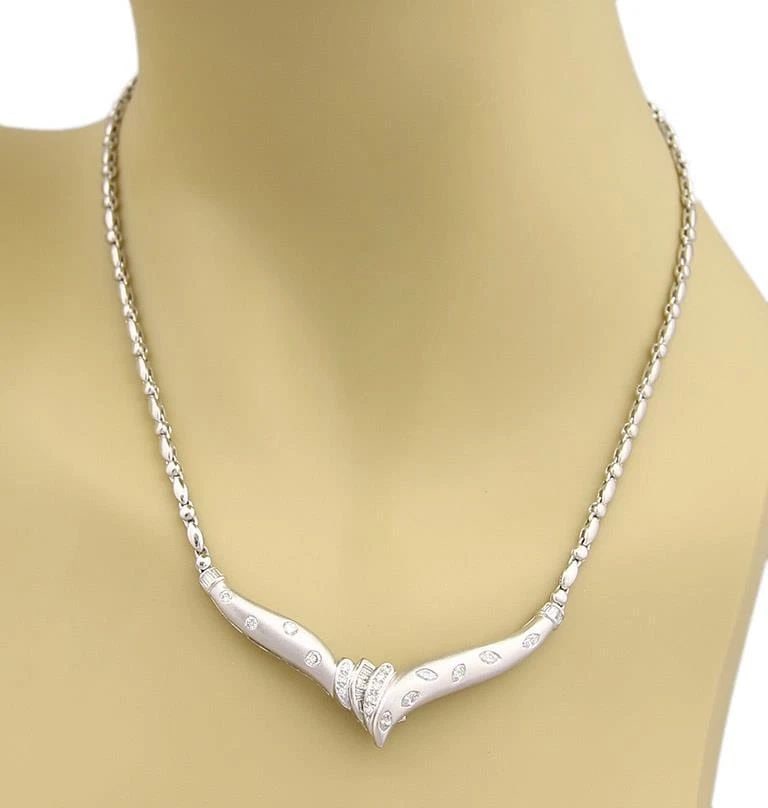 DIAMOND PLATINUM NECKLACE WIDE V PENDANT PUFFED LINK CHAIN: DIAMOND PLATINUM NECKLACE WIDE V PENDANT PUFFED LINK CHAIN This stunning diamond platinum necklace features a wide V pendant with a puffed link chain, showcasing flush set round and marquise shaped na