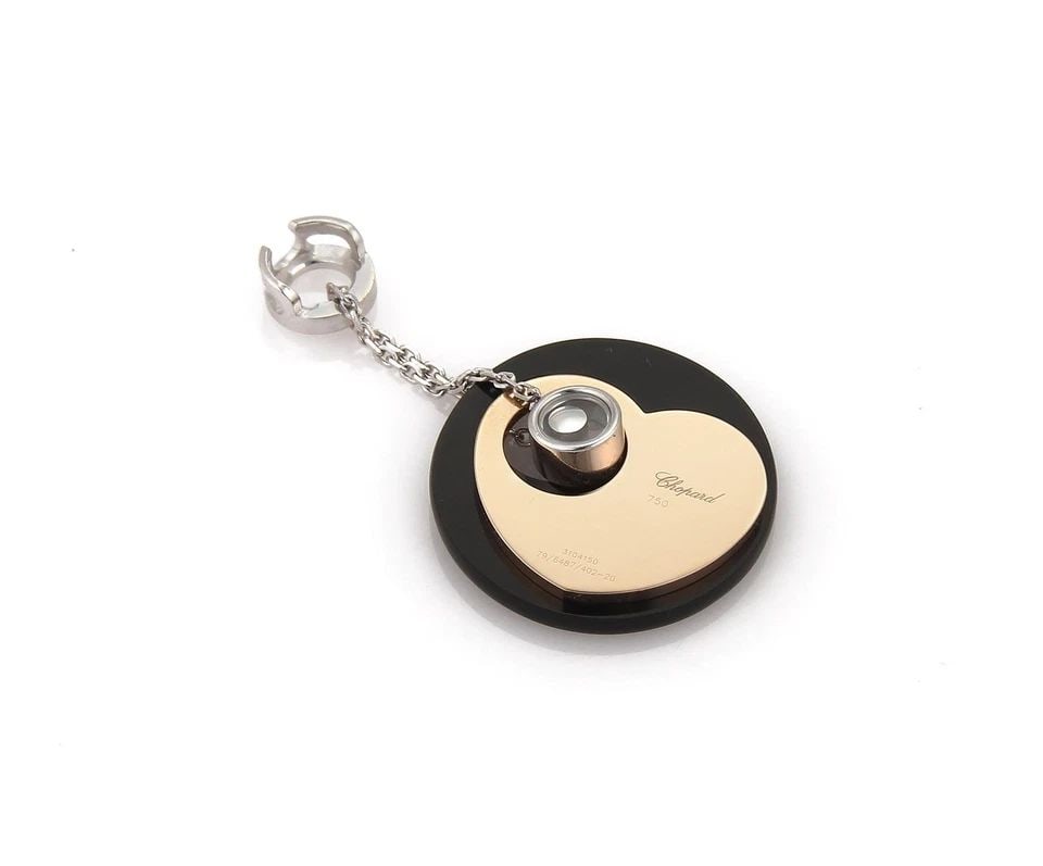 CHOPARD HAPPY DIAMOND ONYX TWO TONE GOLD HEART & CIRCLE FANCY PENDANT: CHOPARD HAPPY DIAMOND ONYX TWO TONE GOLD HEART & CIRCLE FANCY PENDANT Chopard Happy Diamond Onyx Two Tone Gold Heart & Circle Fancy Pendant Description Elite and authentic by Chopard from the Happy Di