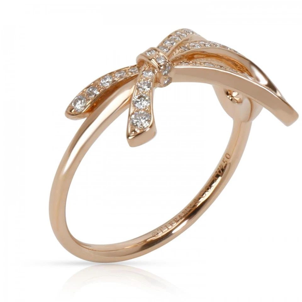 TIFFANY & CO. DIAMOND 18K ROSE GOLD RIBBON BOW RING SIZE 4.75: TIFFANY & CO. DIAMOND 18K ROSE GOLD RIBBON BOW RING SIZE 4.75 Tiffany & Co. Diamond 18k Rose Gold Ribbon Bow Ring Size 4.75 Description This lovely authentic ring is from Tiffany & Co, it is crafted f