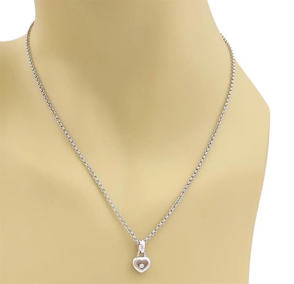 CHOPARD NECKLACE HAPPY DIAMOND 18K WHITE GOLD MINI HEART PENDANT & CHAIN: CHOPARD NECKLACE HAPPY DIAMOND 18K WHITE GOLD MINI HEART PENDANT & CHAIN The Chopard Necklace Happy Diamond is a stunning piece of fine jewelry featuring a mini heart pendant crafted from 18k white go