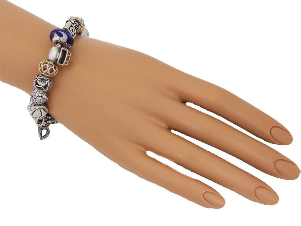 PANDORA ENAMEL 14K GOLD & STERLING WHITE STONE SLIDE CHARMS CABLE BRACELET: PANDORA ENAMEL 14K GOLD & STERLING WHITE STONE SLIDE CHARMS CABLE BRACELET This authentic and charming bracelet is by Pandora, sterling silver cable bracelet assorted style slide charms. Some of the c