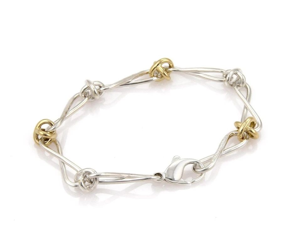 TIFFANY & CO. INFINITY LINK BRACELET PICASSO STERLING SILVER 18K YELLOW GOLD: TIFFANY & CO. INFINITY LINK BRACELET PICASSO STERLING SILVER 18K YELLOW GOLD Tiffany & Co. Picasso 925 Silver 18k Yellow Gold Infinity Link Bracelet Description This is an authentic bracelet from Tiff