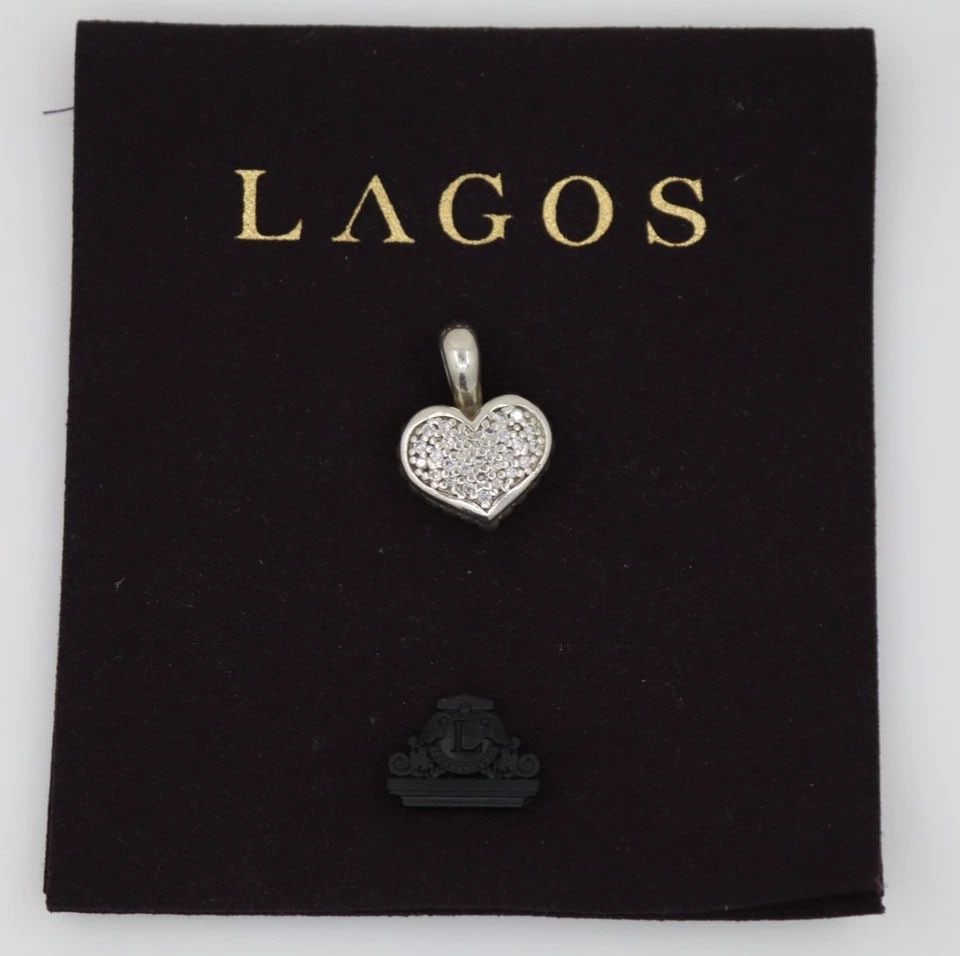 LOGOS STERLING SILVER & 18K YELLOW GOLD DIAMOND HEART PENDANT - 7 GRAMS: LOGOS STERLING SILVER & 18K YELLOW GOLD DIAMOND HEART PENDANT - 7 GRAMS Description Logos Sterling Silver & 18k Yellow Gold Diamond Heart Pendant Pendant is in good condition. May show signs of wear. 