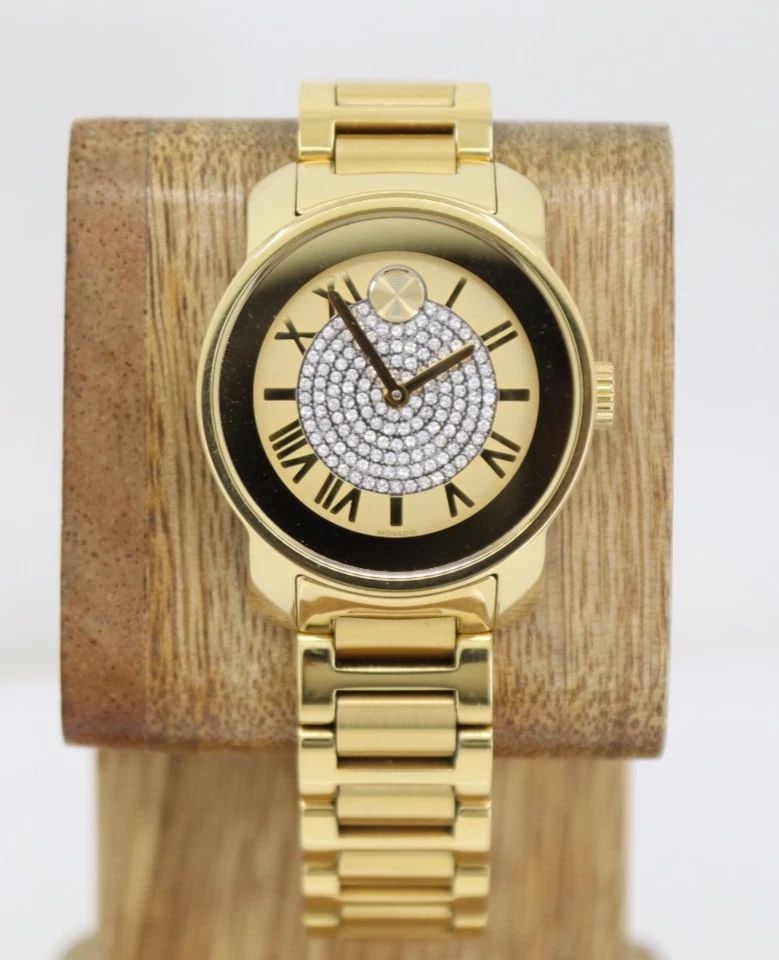 MOVADO BOLD 32MM CHAMPAGNE CRYSTAL DIAL SWISS QUARTZ WOMEN'S WATCH 3600255: MOVADO BOLD 32MM CHAMPAGNE CRYSTAL DIAL SWISS QUARTZ WOMEN'S WATCH 3600255 Description Movado Bold 32mm Champagne Crystal Dial Swiss Quartz Women's Watch 3600255 The watch has been used previously. Th