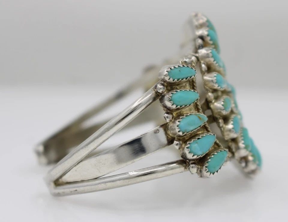 STERLING SILVER TURQUOISE FLOWER CUFF BRACELET 6" - 35.6 GRAMS: STERLING SILVER TURQUOISE FLOWER CUFF BRACELET 6" - 35.6 GRAMS Description Sterling Silver Turquoise Flower Cuff Bracelet Bracelet is in good condition. May show signs of wear and/or tear. Approximate