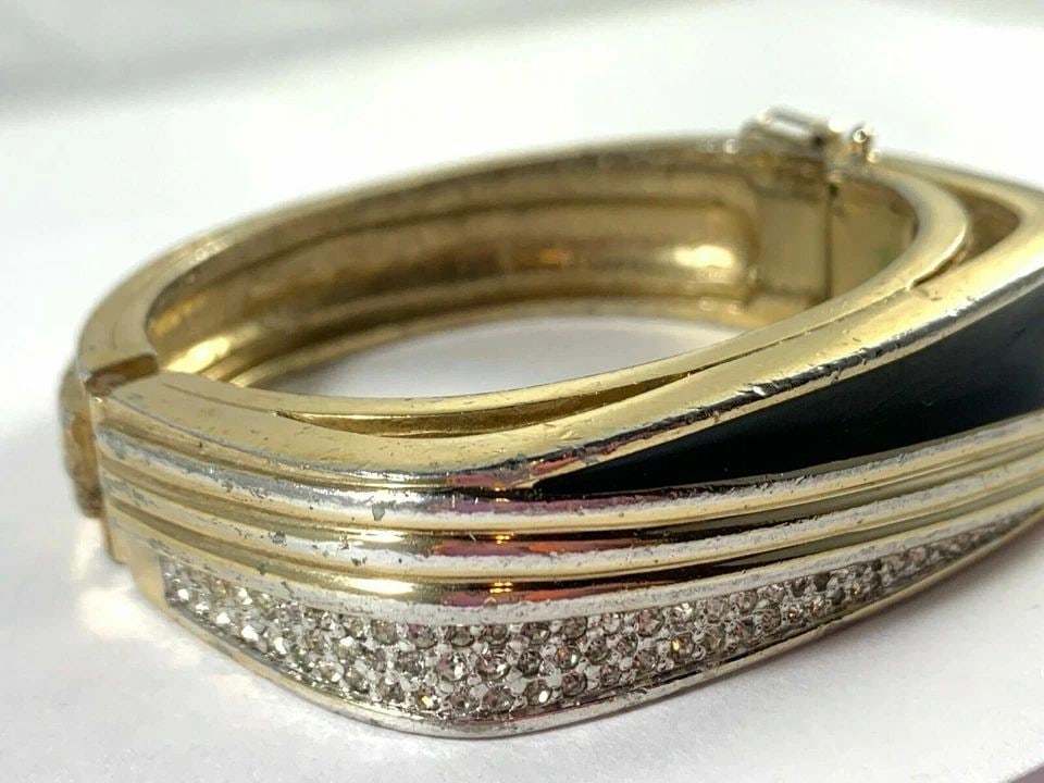 SIGNED PANETTA VINTAGE HINGED BANGLE BRACELET GOLD AND BLACK ENAMEL RHINESTONES: SIGNED PANETTA VINTAGE HINGED BANGLE BRACELET GOLD AND BLACK ENAMEL RHINESTONES Description Signed Panetta Vintage Hinged Bangle Bracelet Gold and Black Enamel Rhinestones **Lots of Scratches / Deep S