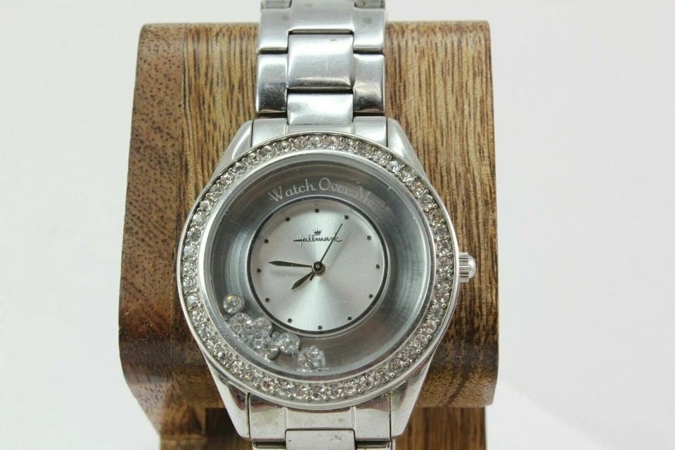 HALLMARK ''WATCH OVER ME''CRYSTAL ACCENTS SILVER DIAL STAINLESS STEEL WATCH: HALLMARK ''WATCH OVER ME''CRYSTAL ACCENTS SILVER DIAL STAINLESS STEEL WATCH Description HALLMARK ''WATCH OVER ME''CRYSTAL ACCENTS SILVER DIAL STAINLESS STEEL MENS WATCH New battery Installed. In great
