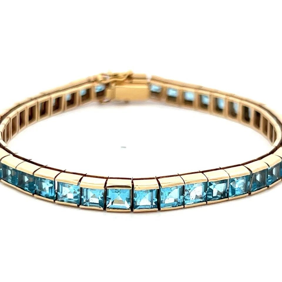 VINTAGE 14K YELLOW GOLD TENNIS BRACELET WITH 4.06X3.31 MM BLUE TOPAZ: VINTAGE 14K YELLOW GOLD TENNIS BRACELET WITH 4.06X3.31 MM BLUE TOPAZ VINTAGE 14K YELLOW GOLD TENNIS BRACELET WITH 4.06X3.31 MM BLUE TOPAZ PRODUCT DESCRIPTION Detailed Description: 20.4 Grams Bask in t
