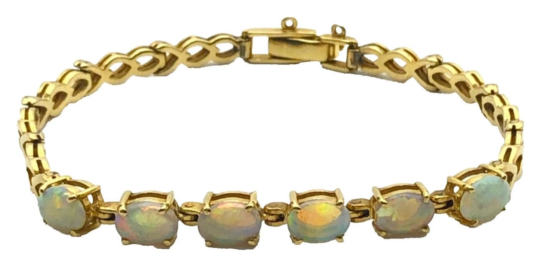 14K GOLD BRACELET WITH NATURAL AAA QUALITY OPALS ( 7.25" ) 12.6G: 14K GOLD BRACELET WITH NATURAL AAA QUALITY OPALS 7.25 INCHES 14k Gold Bracelet with center row of Natural AAA Quality Opals Condition: Used Material: 14k Yellow Gold Weight: 12.6 grams Bracelet Size: 
