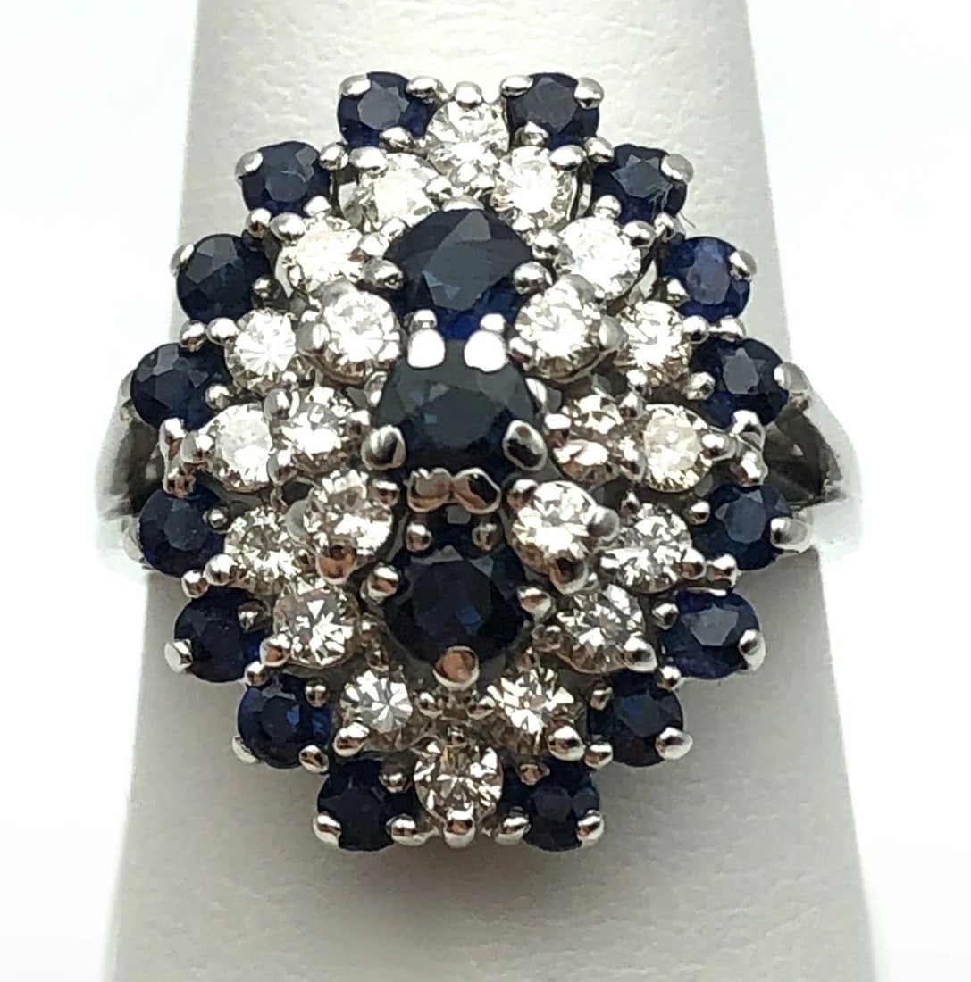 14K WHITE GOLD OVAL CLUSTER RING WITH NATURAL SAPPHIRES AND 0.66CTS OF DIAMONDS: 14K WHITE GOLD OVAL DOME RING WITH NAT SAPPHIRES AND 0.66CTS OF DIAMONDS SIZE 8 14k White Gold oval dome Ring set with Sapphires and 0.66cts of Diamonds Condition: Used, has been moved around in inven