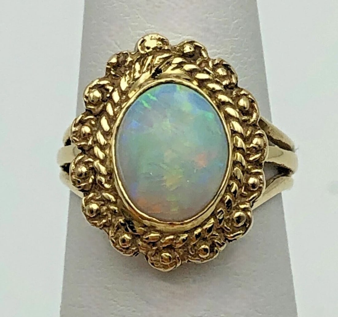 14K GOLD RING WITH 10X8MM NATURAL OPAL (SIZE: 5.25) 5.4 GRAMS: 14K GOLD RING SET WITH NATURAL OPAL SIZE: 5.25 14k Gold Ring set with Natural Opal Condition: Used Material: 14k Yellow Gold Ring Size: 5.25 Weight: 5.4 grams Top Width: 17mm Bottom Width: 3.2mm Stone