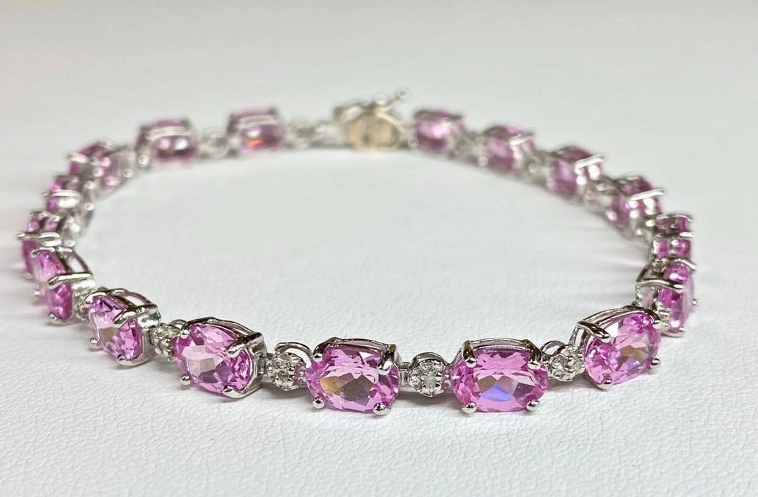 10K WHITE GOLD BRACELET, 0.08CTS OF DIAMONDS AND PINK C.Z. ( 7 INCH ) 8.5G: 10k White Gold Bracelet, 0.08cts of Diamonds and Pink C.Z. You are bidding on a pre-owned Women's 10k White Gold Bracelet with Diamonds and Pink Stones. The bracelet has minor scuffs and scratches fro