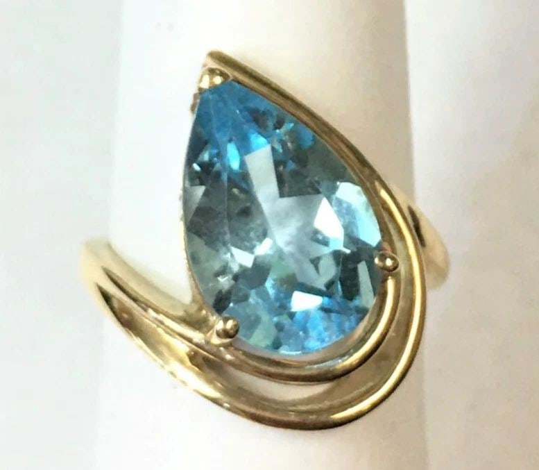 14K GOLD RING WITH PEAR CUT BLUE TOPAZ (SIZE 6.5) 5.6 GRAMS: 14k Gold Ring with pear shaped Blue Topaz You are bidding on a 14k Gold Ring with big center Pear Blue Topaz. The ring has been fully checked and inspected by our in house Jewelers. The ring has some 