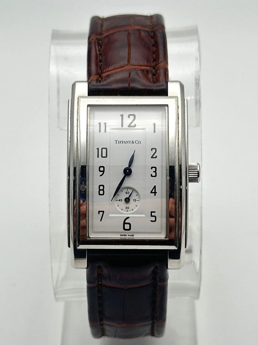 TIFFANY & CO. STAINLESS STEAL W/ LEATHER BAND UNISEX WATCH 27MM: TIFFANY & CO. STAINLESS STEAL W/ LEATHER BAND UNISEX WATCH Tiffany & Co. Stainless Steal W/ Leather Band Unisex Watch You are bidding on a pre-owned Tiffany & Co. Stainless Steal W/ Leather Band Unise