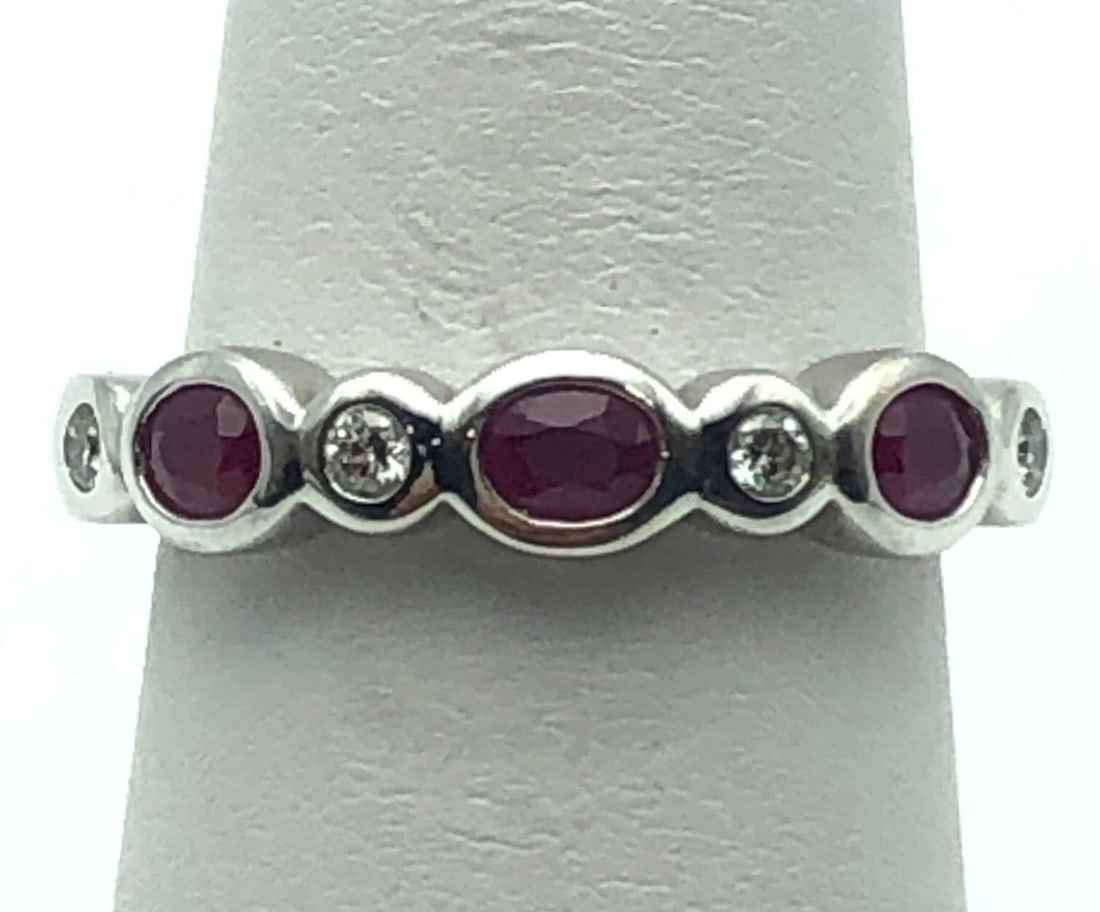 14K WHITE GOLD RING WITH NATURAL RUBIES AND 0.12CTW DIAMONDS (SIZE 7) 4.1 GRAM: 14K WHITE GOLD RING SET WITH NATURAL RUBIES AND 0.12CTS OF DIAMONDS SIZE: 7 14k White Gold Ring set with Natural Rubies and 0.12cts of Diamonds Condition: Used Material: 14k White Gold Ring Size: 7 We