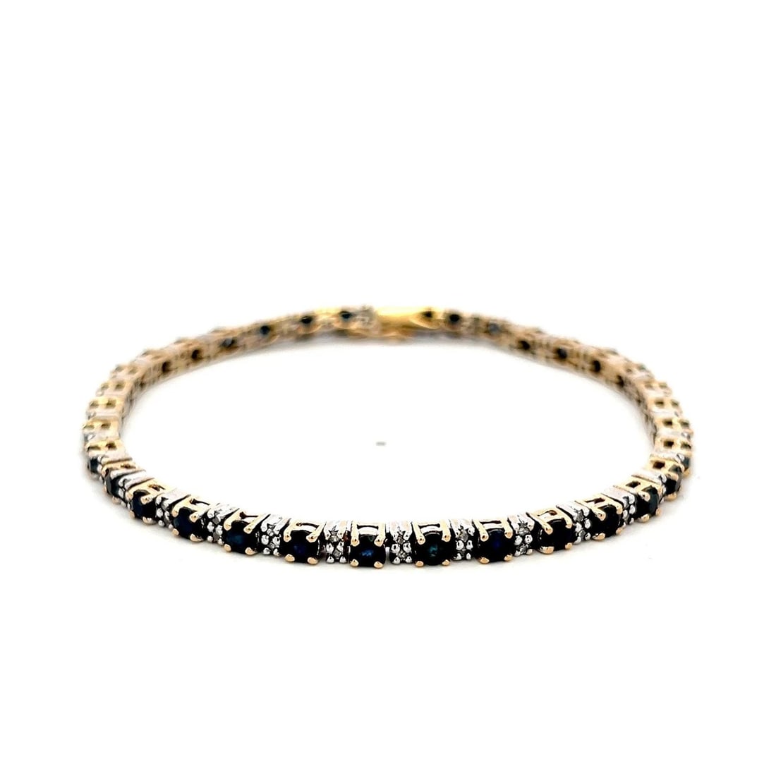 14K TWO TONE GOLD TENNIS BRACELET WITH 0.68 CARAT DIAMONDS & 4.08 CARAT SAPPHIRE: 14K TWO TONE GOLD TENNIS BRACELET WITH 0.68 CARAT DIAMONDS & 4.08 CARAT SAPPHIRE Detailed Description: Elevate your style with this vintage two-tone tennis bracelet, showcasing a dazzling combination 