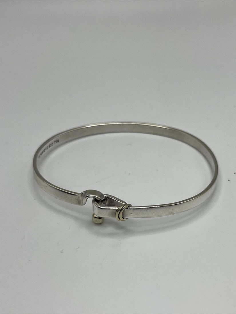 TIFFANY & CO. STERLING SILVER BRACELET WITH 18KT YELLOW GOLD ACCENTS: TIFFANY & CO. STERLING SILVER BRACELET WITH 18KT YELLOW GOLD ACCENTS TIFFANY & CO. STERLING SILVER BRACELET WITH 18KT YELLOW GOLD ACCENTS Elevate your jewelry collection with this stunning Tiffany &am