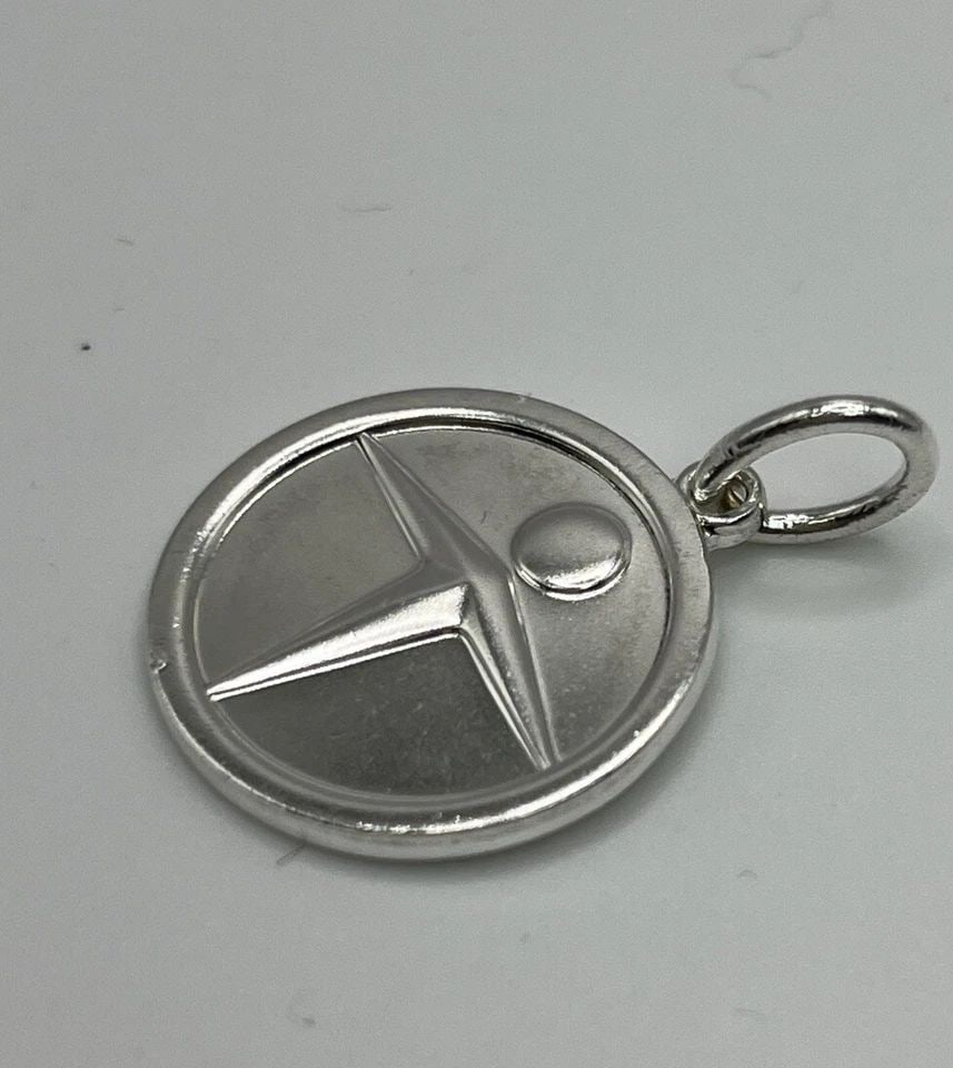 TIFFANY & CO. STERLING SILVER MANPOWER CHARM WITH BALE: TIFFANY & CO. STERLING SILVER MANPOWER CHARM WITH BALE TIFFANY & CO. STERLING SILVER MANPOWER CHARM WITH BALE Tiffany & Co. Sterling Silver Manpower Charm with BaleApproximate weight is 6.2 g