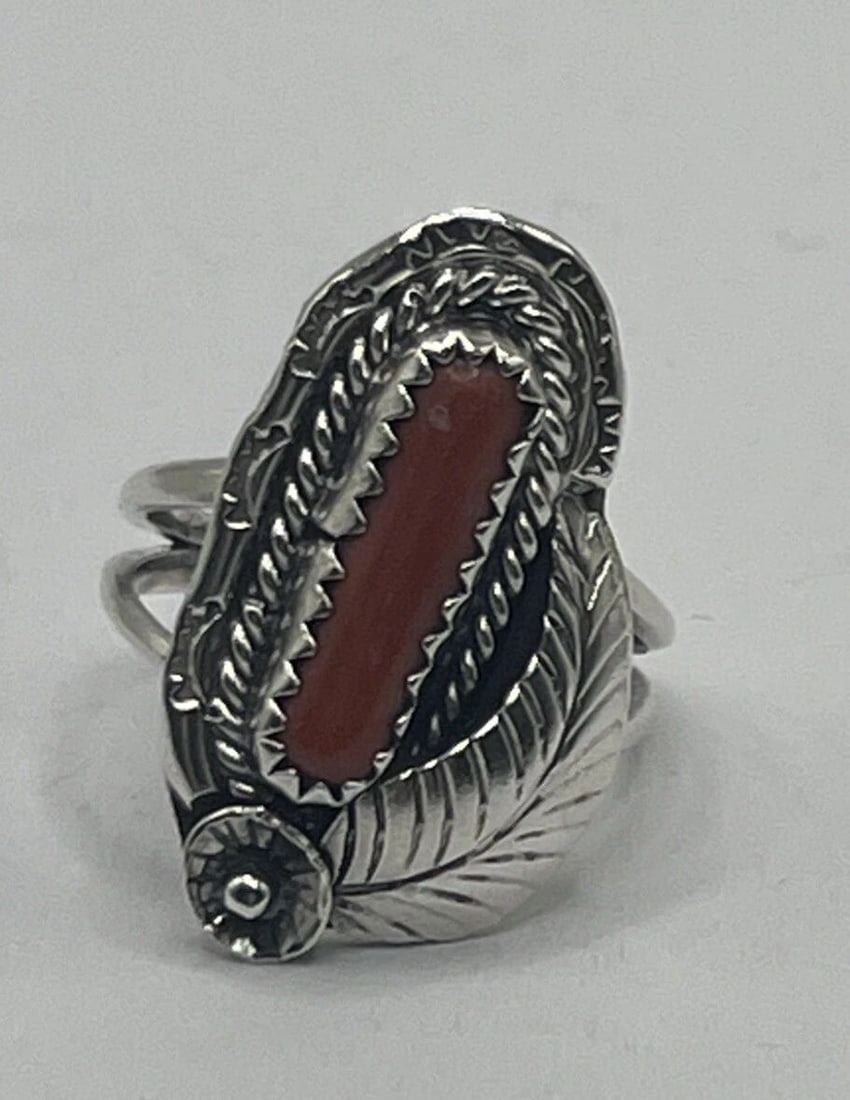 STERLING SILVER & CORAL SIZE 5.5: STERLING SILVER & CORAL SIZE 5.5 This is a beautiful Sterling Silver ring featuring a vibrant Coral gemstone in a size 5.5. The ring is crafted from 925 Sterling Silver, known for its durability and l