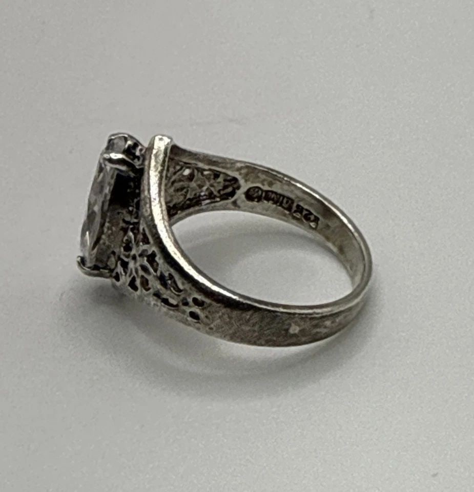 STERLING SILVER RING WITH COLORLESS MARQUISE STONE SIZE 7.5: STERLING SILVER RING WITH COLORLESS MARQUISE STONE SIZE 7.5 This product is a beautiful sterling silver ring with a colorless marquise stone, perfect for adding a touch of elegance to any outfit. The 