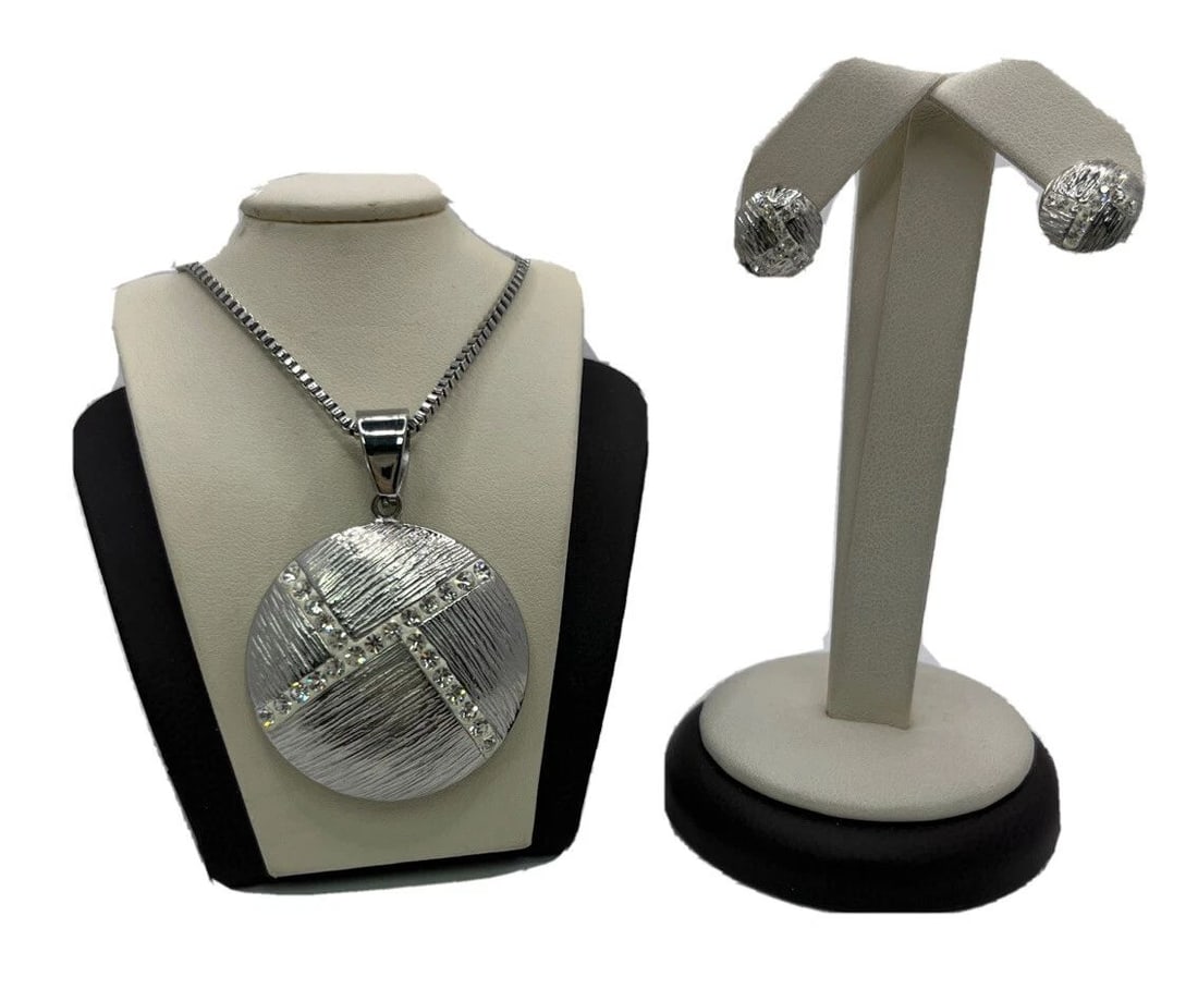 SILVER PENDANT ON 20" CHAIN WITH MATCHING PIERCED EARRINGS: SILVER PENDANT ON 20" CHAIN WITH MATCHING PIERCED EARRINGS SILVER PENDANT ON 20" CHAIN WITH MATCHING PIERCED EARRINGS Pretty designed pendant with CZ stones inlayed.He pendant and the earrings match e